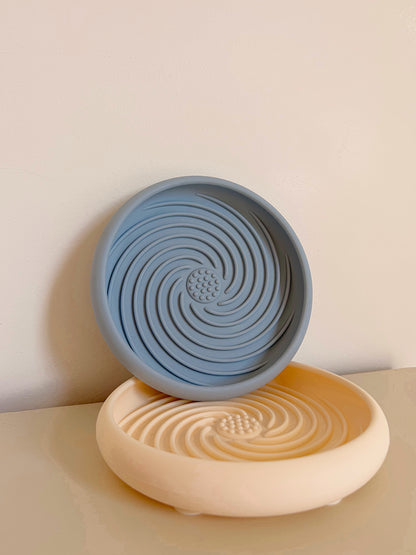 Le Nuage Bowl Ayos Club, tapis de léchage apaisant en silicone alimentaire, présenté en coloris bleu et beige avec ventouses antidérapantes pour l’occupation et le bien-être du chien.